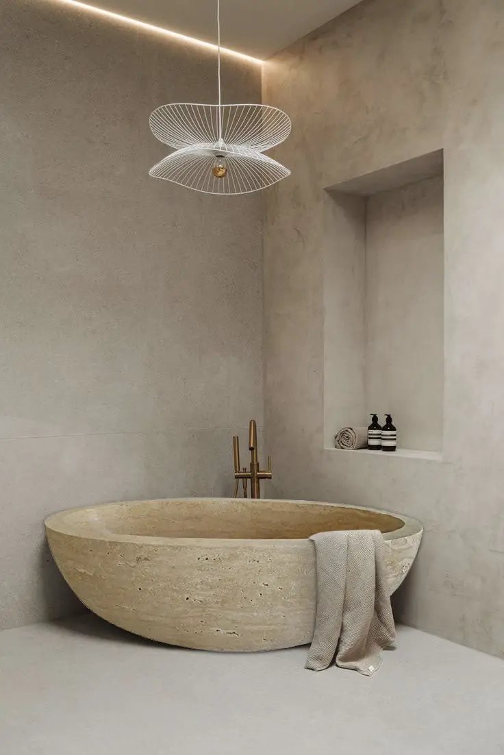 Troia Light Travertine Bathtub, beige oval stone tub with smooth hand-carved finish for a luxurious bathroom look