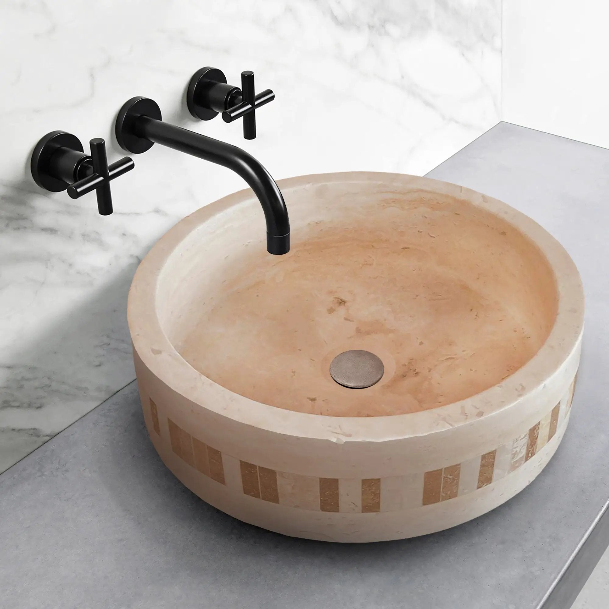 Troia Light Travertine cylinder vanity sink with a 2-inch embedded mosaic border and matte black wall faucet