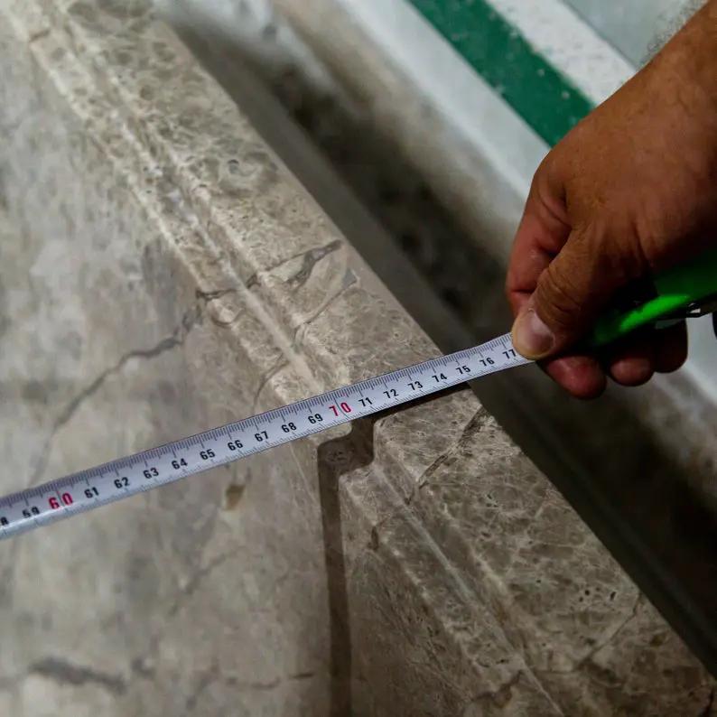 Tundra Gray Marble Bathtub, hand-carved from solid marble block, gray veining, being measured