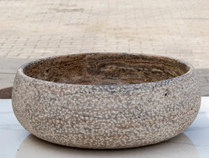Valencia Travertine above-counter bathroom sink by Villohome, round rustic sand-blasted stone bowl.