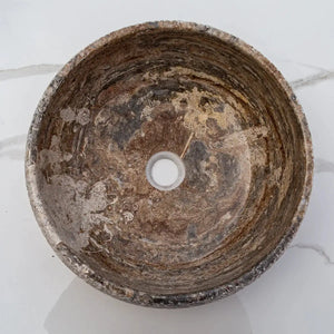 Valencia travertine above-vanity bathroom sink, circular stone basin with rustic sand-blasted finish, 16-inch diameter.