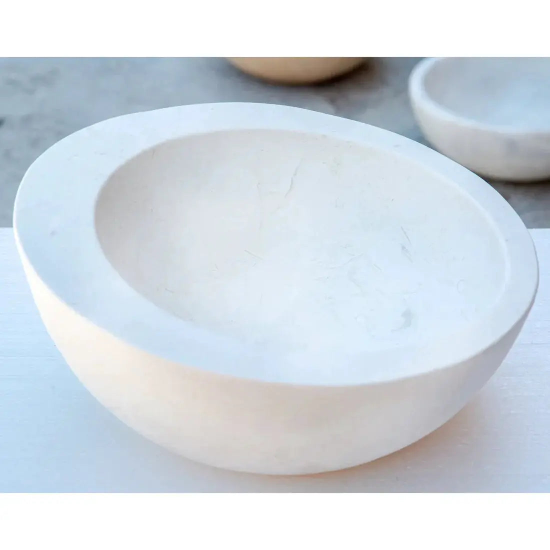 White limestone vanity bathroom sink by Villohome; oval natural stone basin.