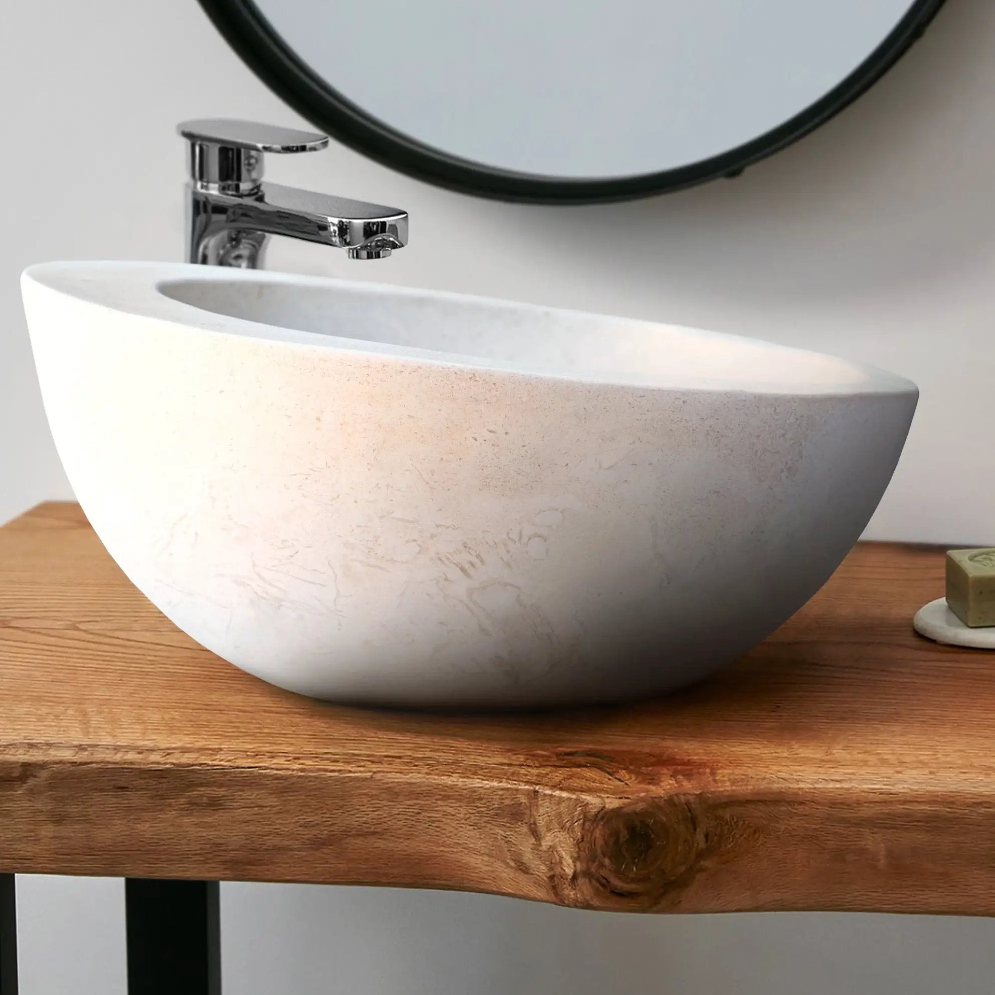 White limestone vanity bathroom sink with sloped rim and chrome faucet
