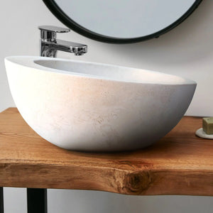 White limestone vanity bathroom sink with sloped rim and chrome faucet