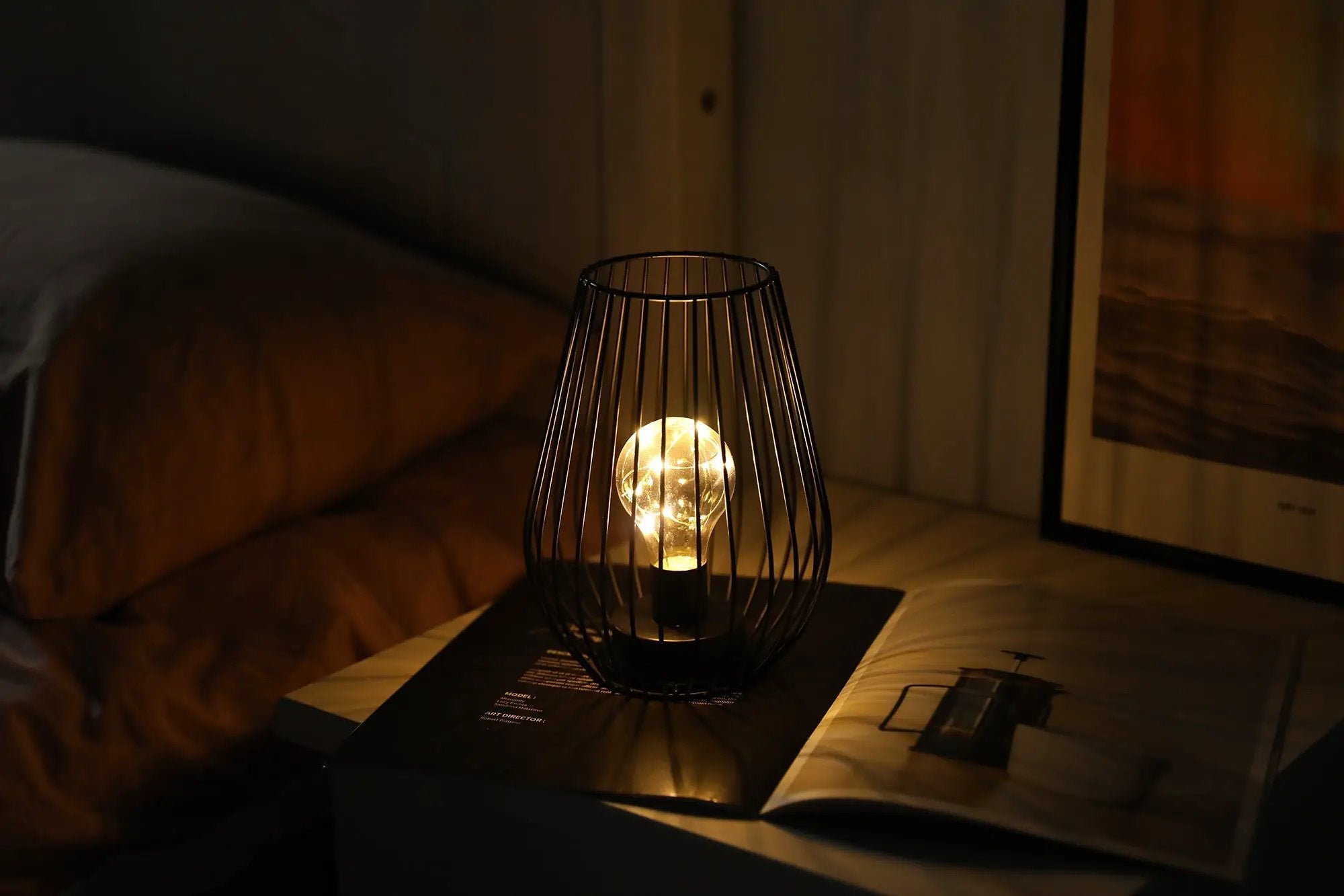 8-inch tall cage-shaped table lamp, battery-powered with a warm glowing bulb by JHY DESIGN