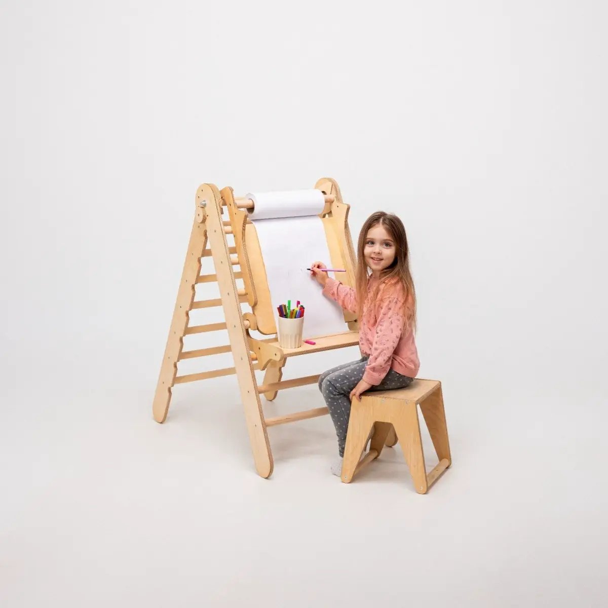 Art Addition to the Triangle Ladder wooden easel with paper roll, girl drawing with colored pencils.