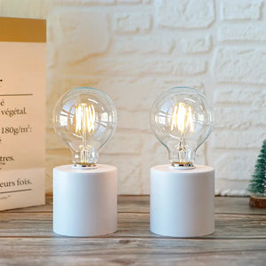 Set of 2 7in tall white battery-operated table lamps with clear glass bulbs by JHY DESIGN