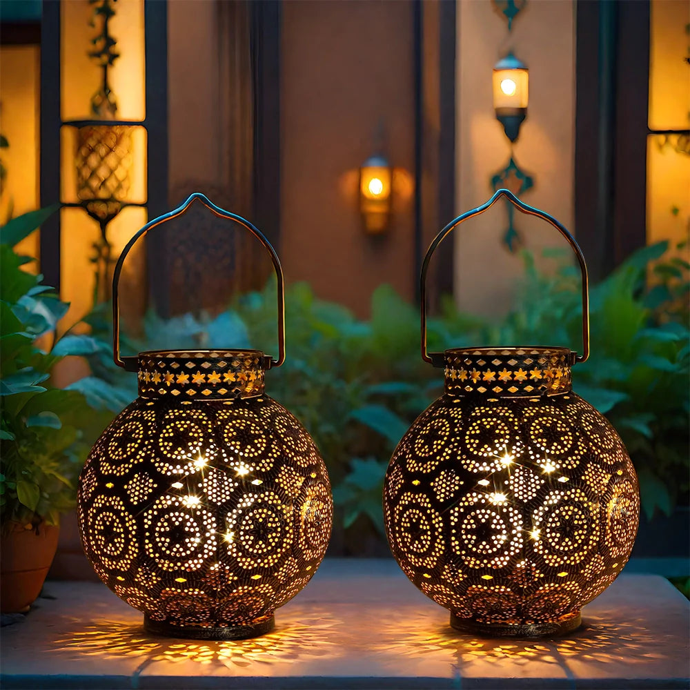 Set of 2 JHY DESIGN Moroccan-style metal table lamps battery-operated with intricate perforated patterns and warm light.