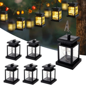 Set of 6 solar lantern lights; black metal frames with glass and warm LED string lights for landscape lighting.