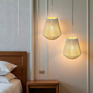 Three 8-inch battery-powered woven hemp rope hanging lamps with warm glow in a bedroom beside a wooden nightstand