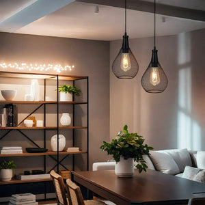 Battery operated hanging lamps; two black mesh pendant lights with warm bulbs in a modern dining area