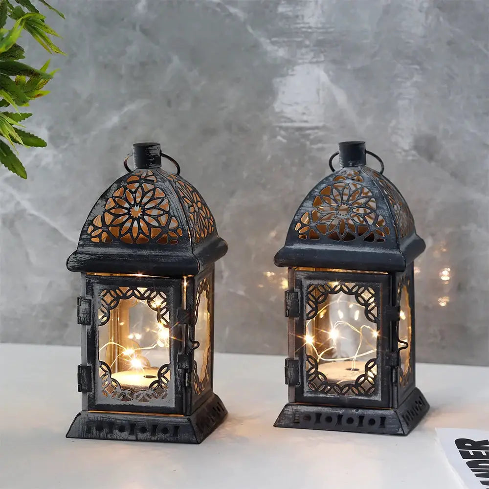 Set of 2 grey battery-operated lanterns with vintage lattice panels and warm interior lights.
