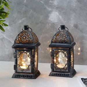 Set of 2 grey battery-operated lanterns with vintage lattice panels and warm interior lights.