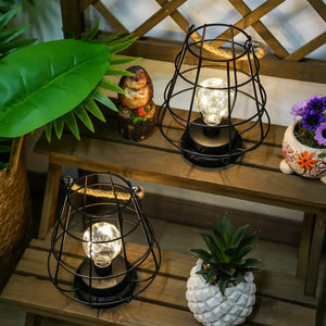 Set of 2 decorative cage bulb lantern table lamps, black metal frames with rope accents and glowing filament bulbs.