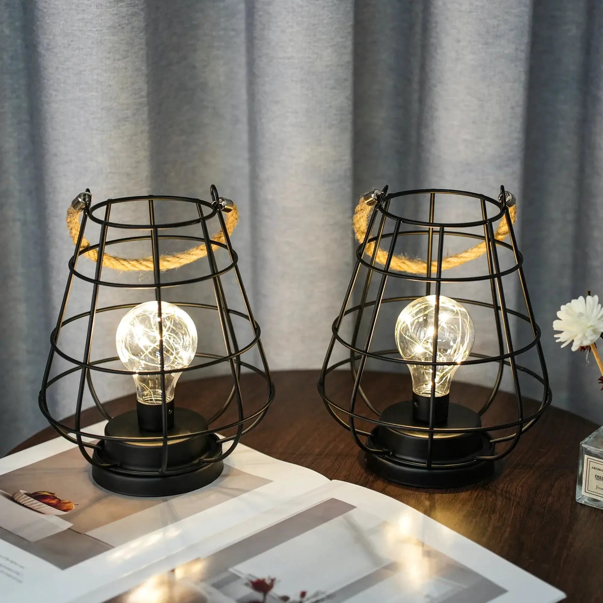 Set of 2 battery-operated cage bulb lantern table lamps with black metal wire cages and rope handles
