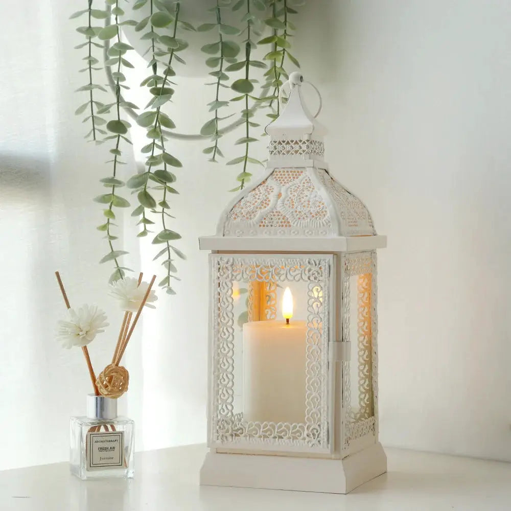 19'' High Decorative Hanging Lantern Cream with ornate lattice panels and a candle inside; diffuser bottle nearby (2 items shown).