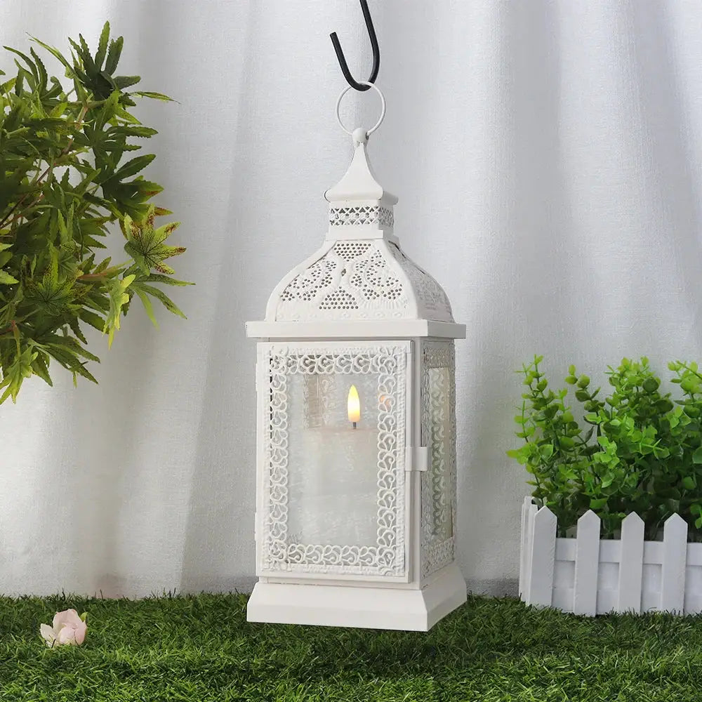19'' High cream decorative hanging lantern with ornate lattice panels and a lit candle inside