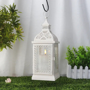 19'' High cream decorative hanging lantern with ornate lattice panels and a lit candle inside