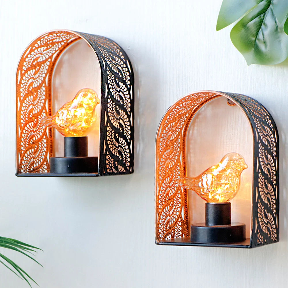 Set of 2 bird-bulb wall sconces by JHY DESIGN with lace metal frames and warm amber fairy lights.