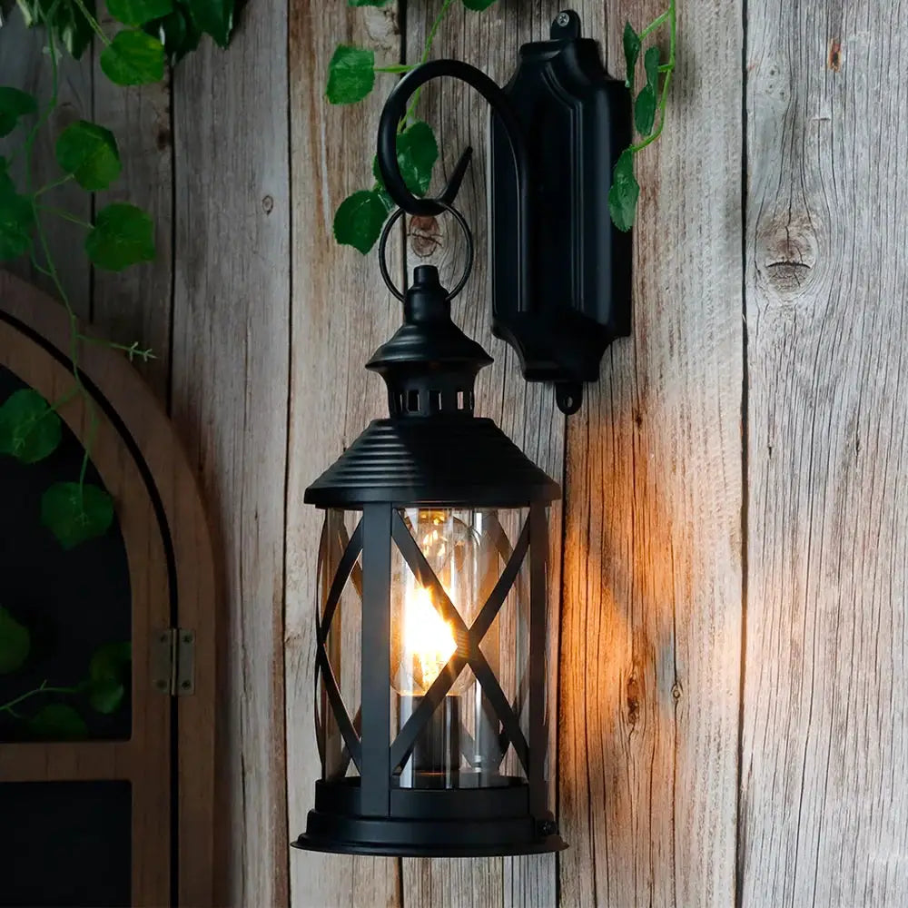 10-inch tall black battery-powered metal lantern lamp with hook, wall-mounted, lit