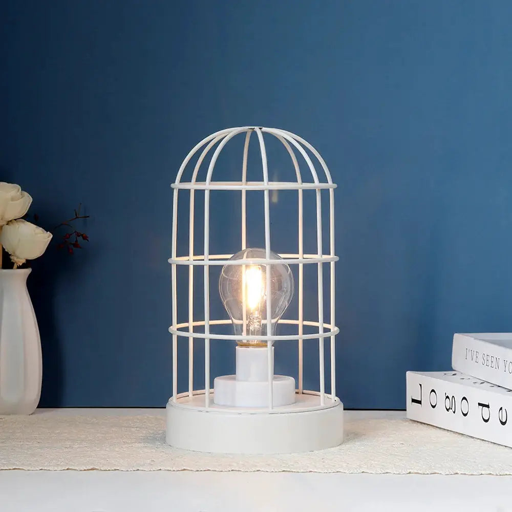 9.5-inch tall decorative metal cage table lamp, white, vintage-style, battery-operated.