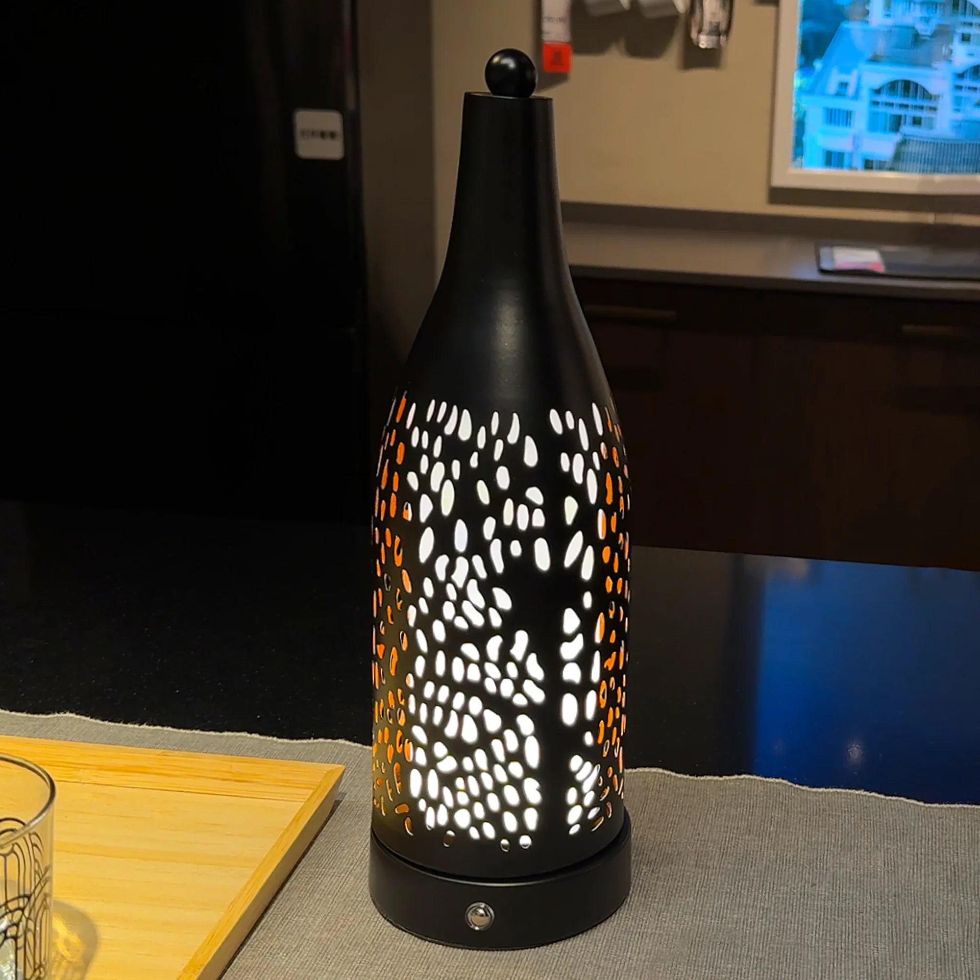 Cordless table lamp with a black cone-shaped perforated shade and a 4000mAh rechargeable battery.