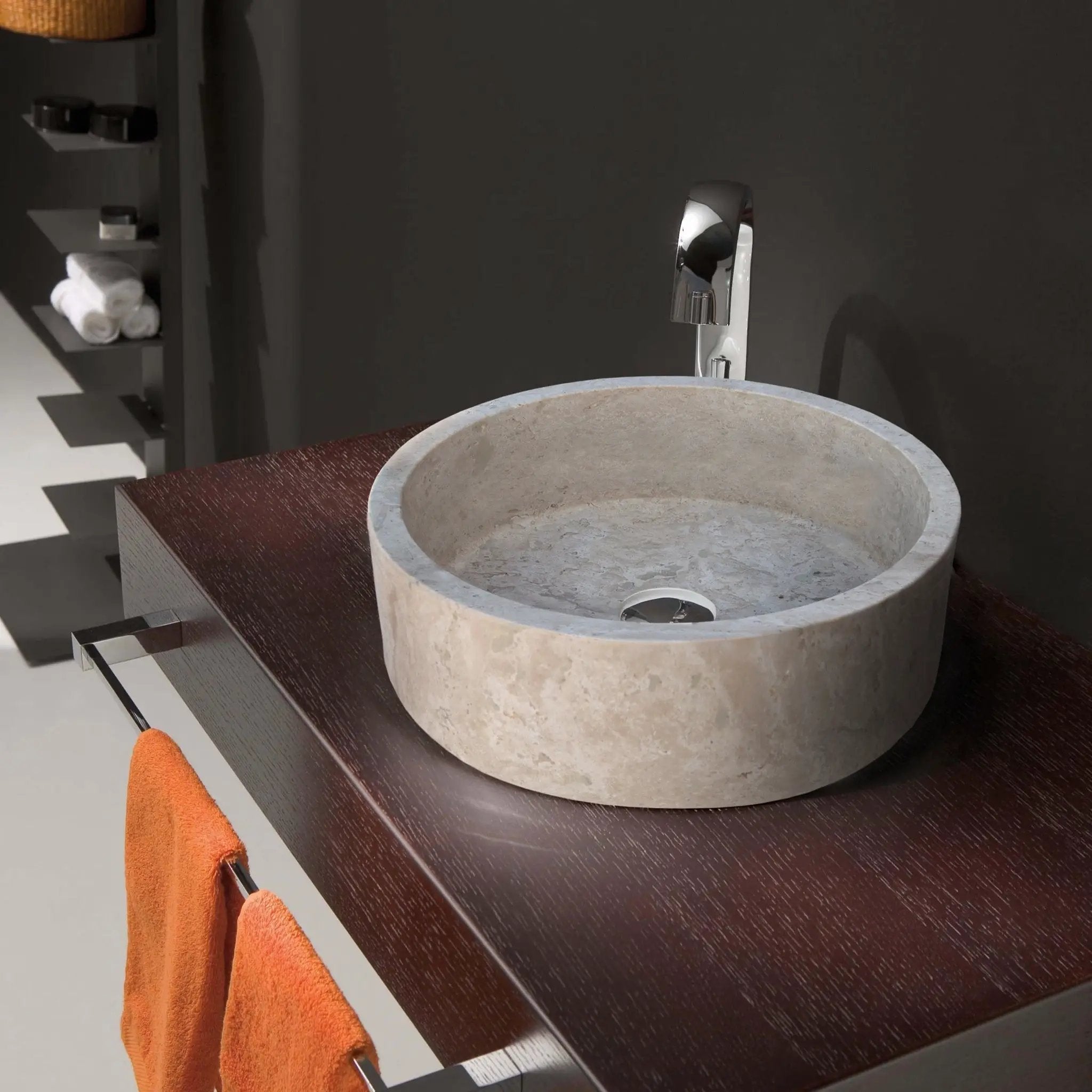 Stone sink round beige travertine above vanity with chrome faucet