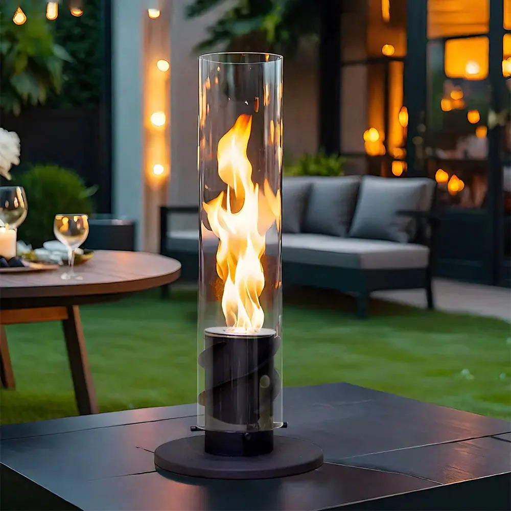 17in Clean-Burning Bio Ethanol Ventless Fireplace on outdoor table with tall glass cylinder and warm flames