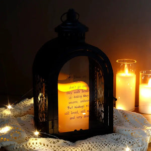 11-inch black memorial lantern with automatic timer and amber glow.