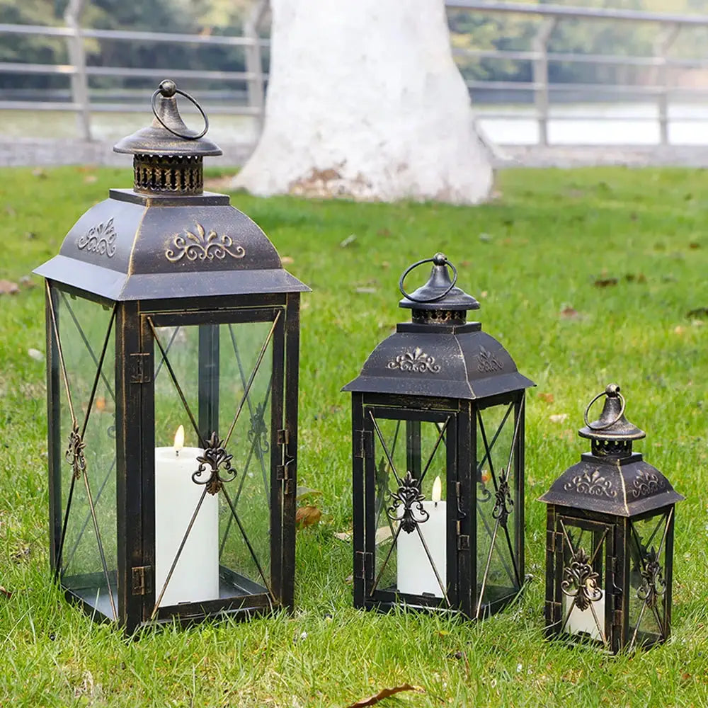 Set of 3 black decorative candle lanterns with glass panels and ornate metalwork