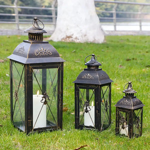 Set of 3 black decorative candle lanterns with glass panels and ornate metalwork