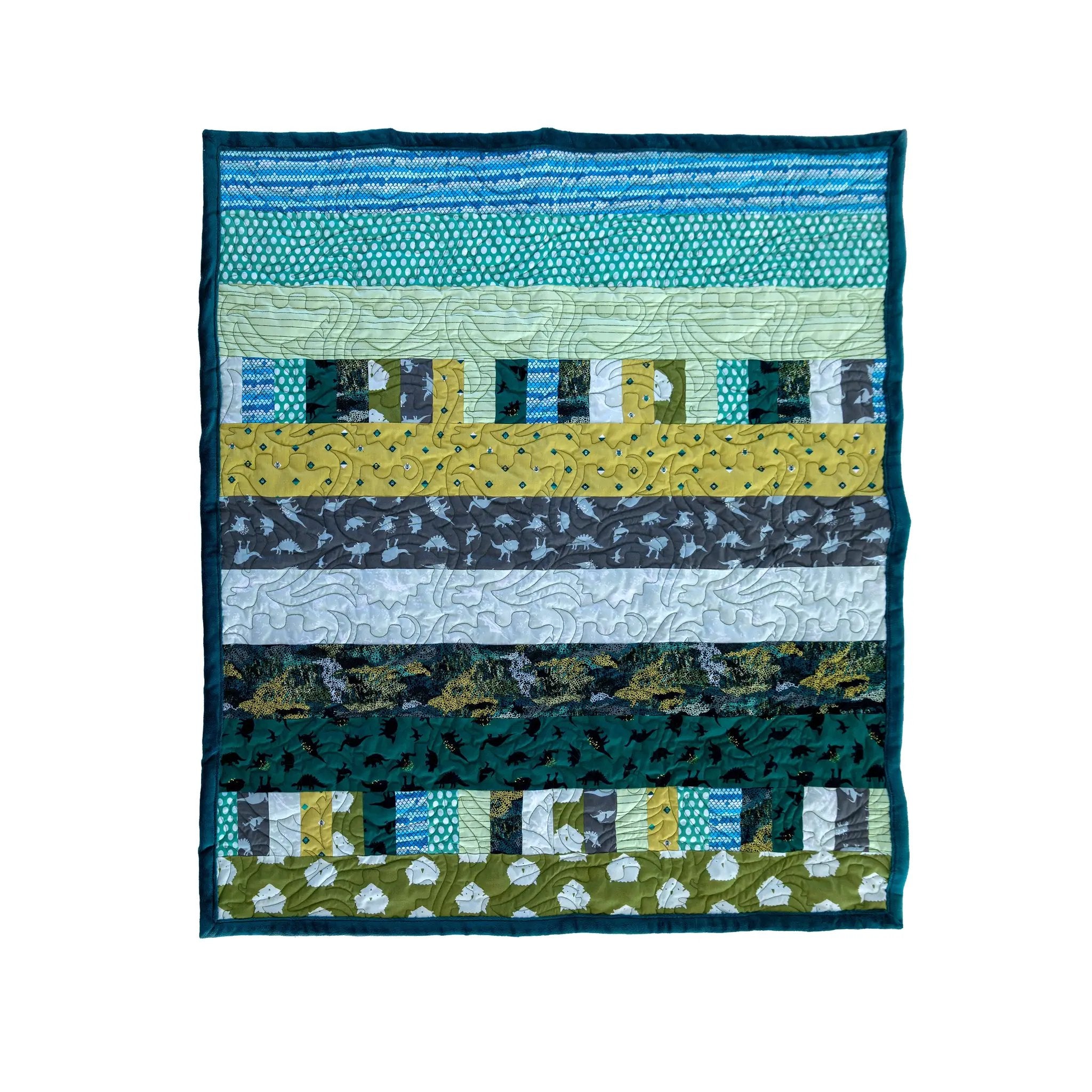 Quilt Kit Bricks and Beams Dinosaurs by Block Party Quilt Co; fabric-strip quilt kit in teal, blue, and green.