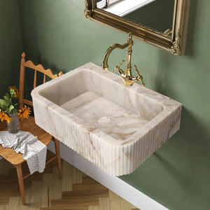 Calacatta Gold marble wall-mount bathroom vanity sink with fluted sides and gold faucet