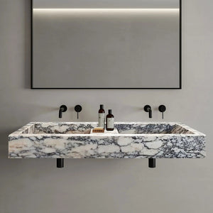 Calacatta Viola marble double bathroom sink with polished finish and black faucet fixtures.