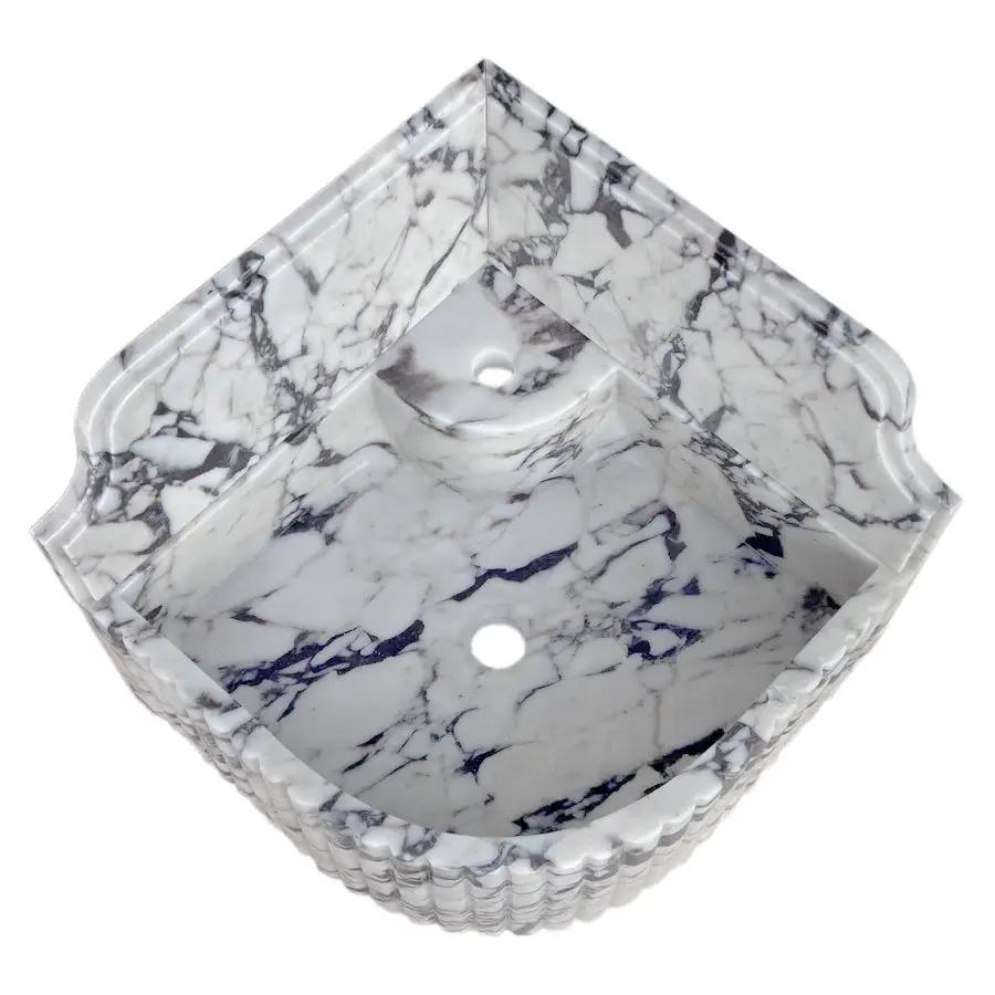 Calacatta Viola marble wall-mount corner sink by Villohome, fluted edges