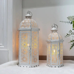 Set of 2 white metal lanterns with intricate floral lattice, 15 in and 19.5 in tall, distressed vintage finish