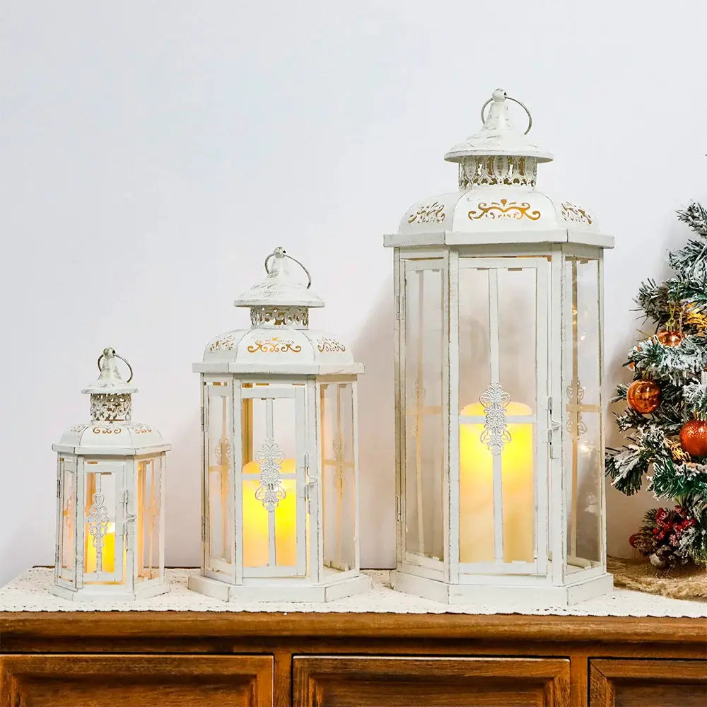 Set of 3 decorative white metal candle lanterns with gold brush accents; 20, 14 and 10 inches tall with glass panels
