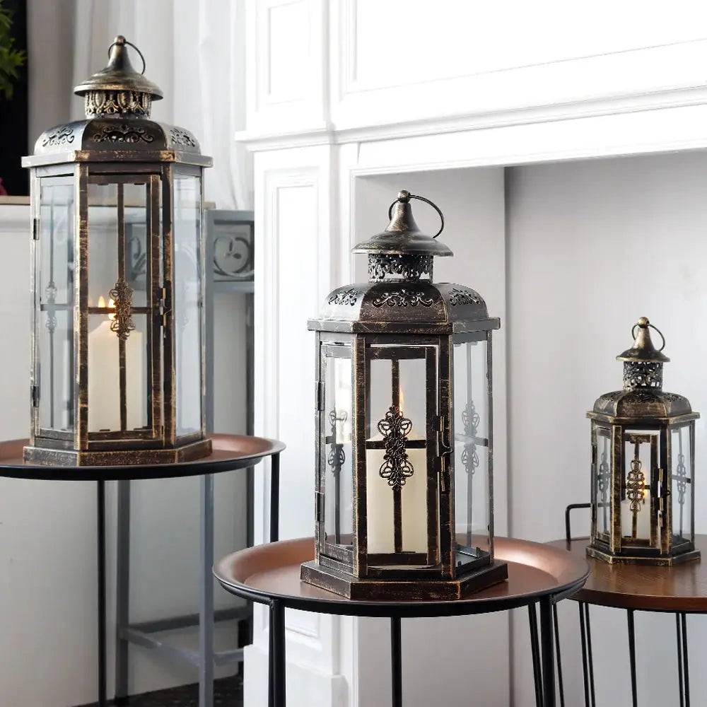 Set of 3 decorative candle lanterns in vintage black metal with gold brush finish.