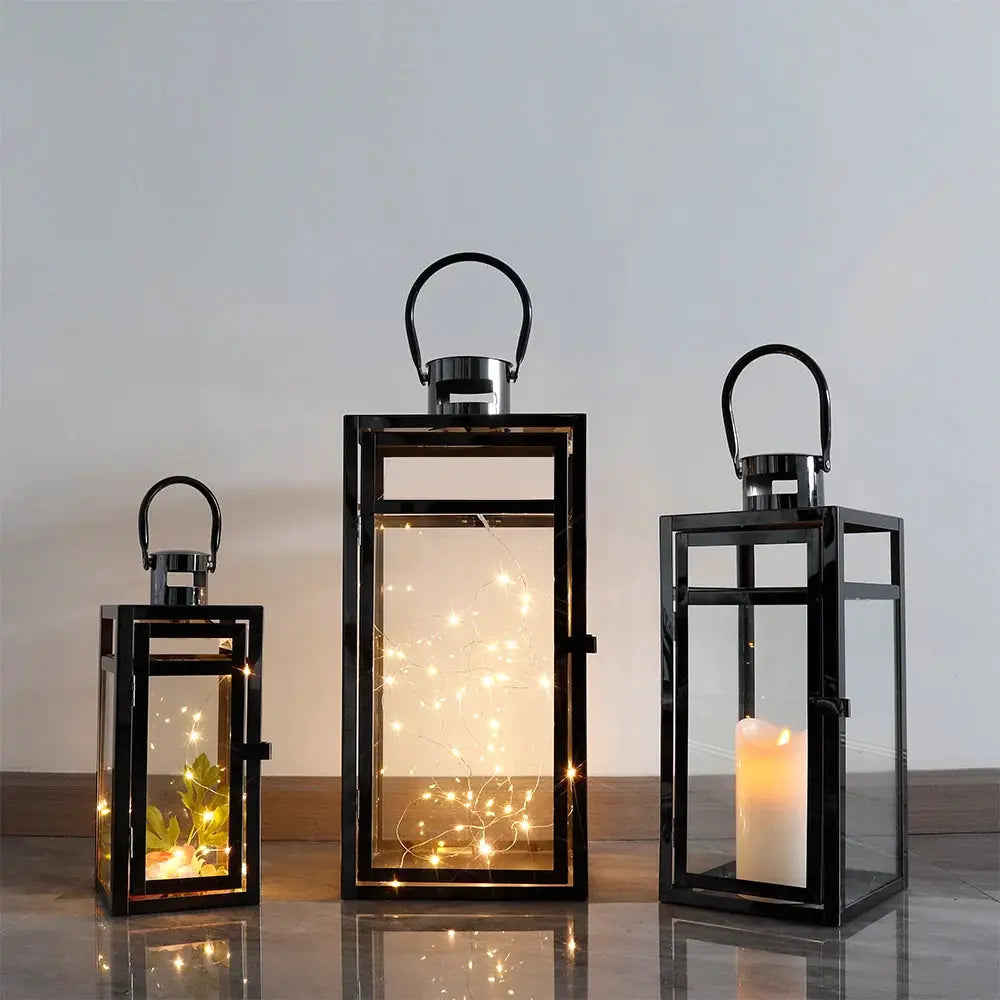 Set of 3 black stainless steel lanterns with glass panels and handles in three sizes