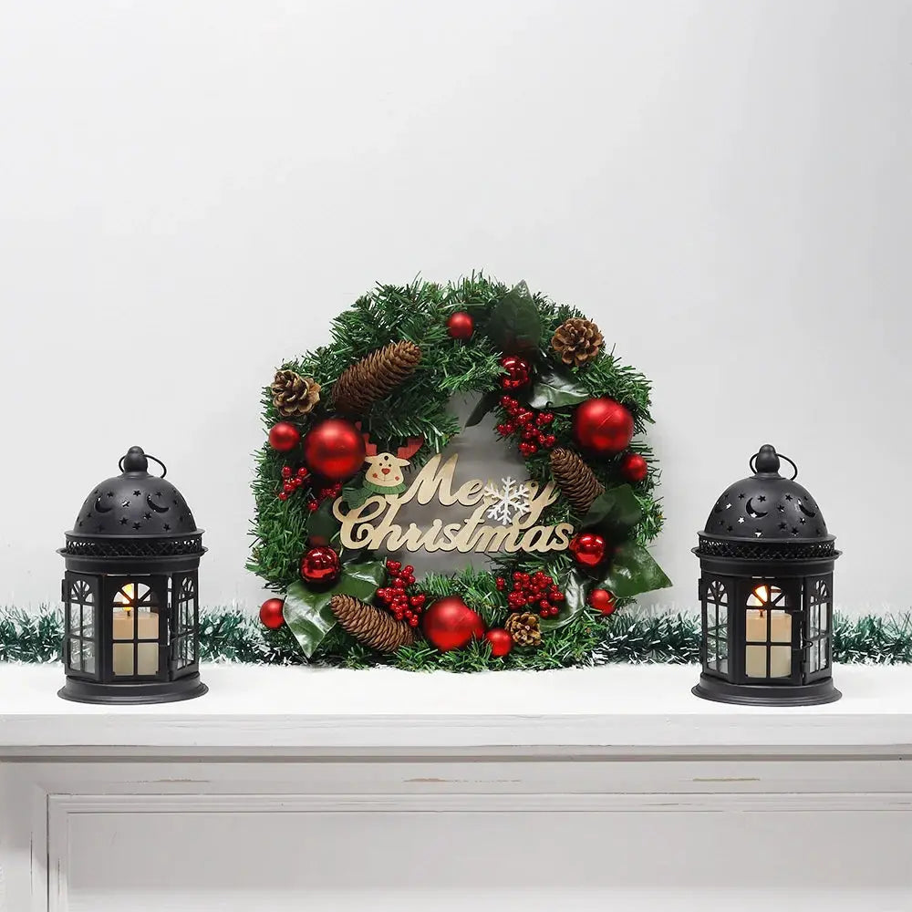 JHY DESIGN 8.5-inch high decorative candle lanterns, set of 2, black metal, displayed with a Christmas wreath.