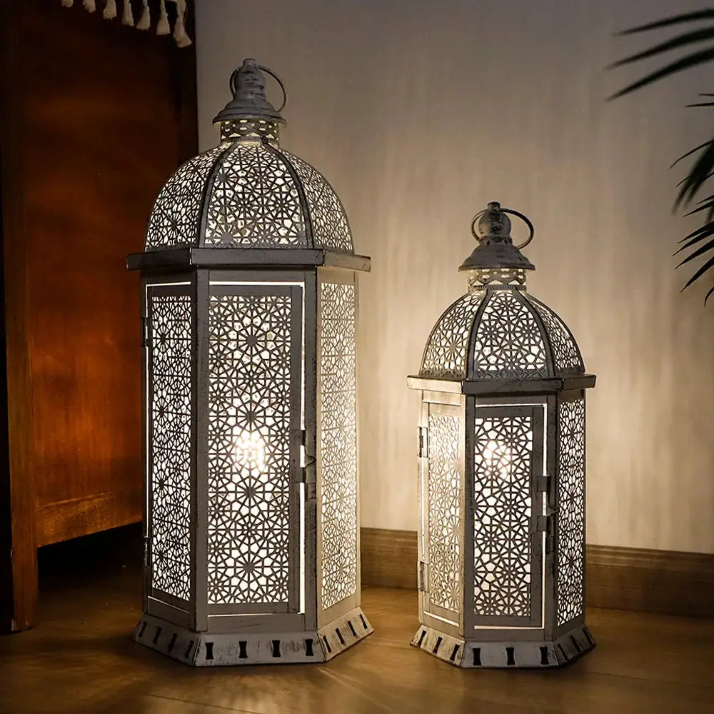 Set of 2 white metal lanterns with intricate lattice panels, 15 in and 19.5 in tall, by JHY DESIGN