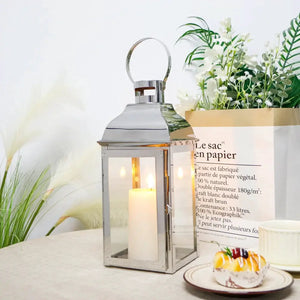 12.5-inch high decorative candle lanterns by JHY DESIGN, silver metal frame with glass panels and a lit candle.