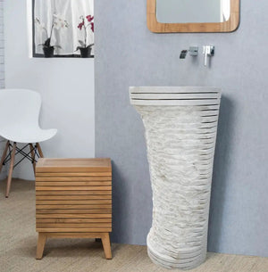 Carrara white marble pedestal sink with a tall ribbed stone base