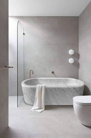 Villohome imperial white marble freestanding bathtub with veining and a towel draped over edge