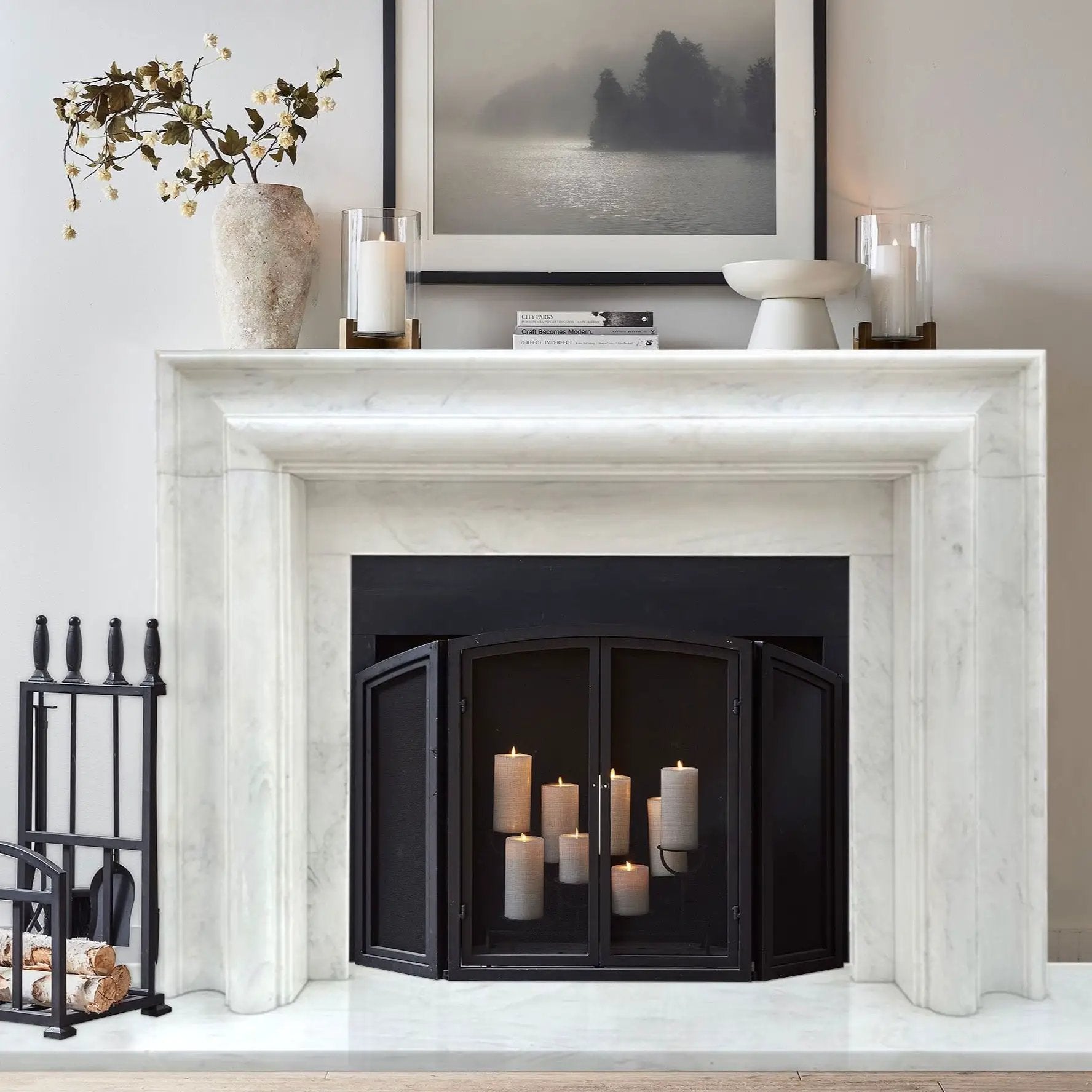 Villohome Carrara white marble fireplace mantel with polished veining, black firebox, and several candles.
