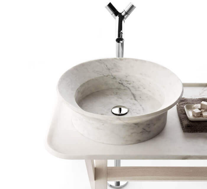 Villohome marble above-counter vessel sink, white marble, 20in dia by 6in high, on white vanity with chrome faucet.