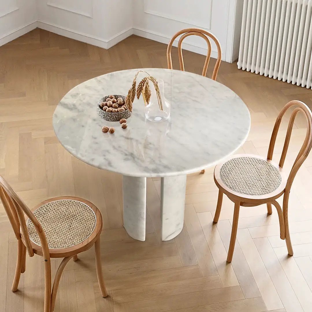 Carrara white marble round dining table with round marble legs, 48in dia, 36in h, with four caned-seat bentwood chairs