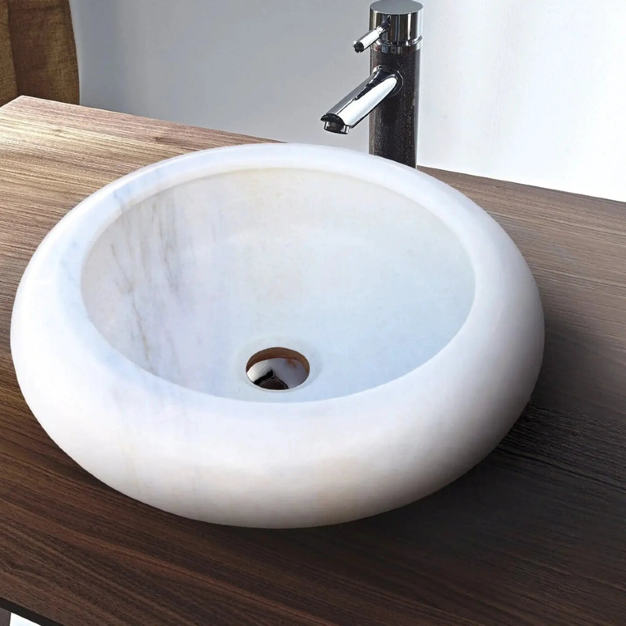Natural Carrara White marble above-counter bathroom sink with chrome faucet