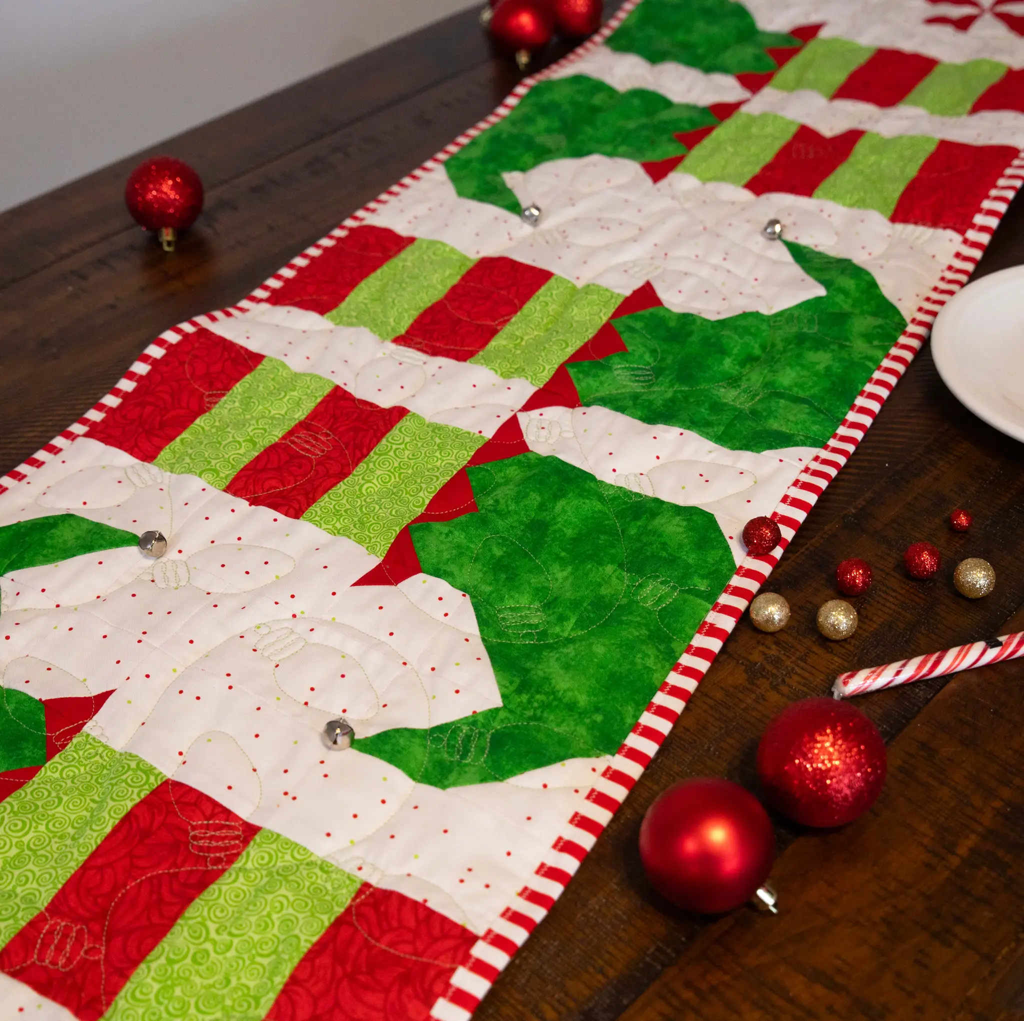 Holiday Quilted Table Runner Kit Bundle in red, green, and white with striped binding.