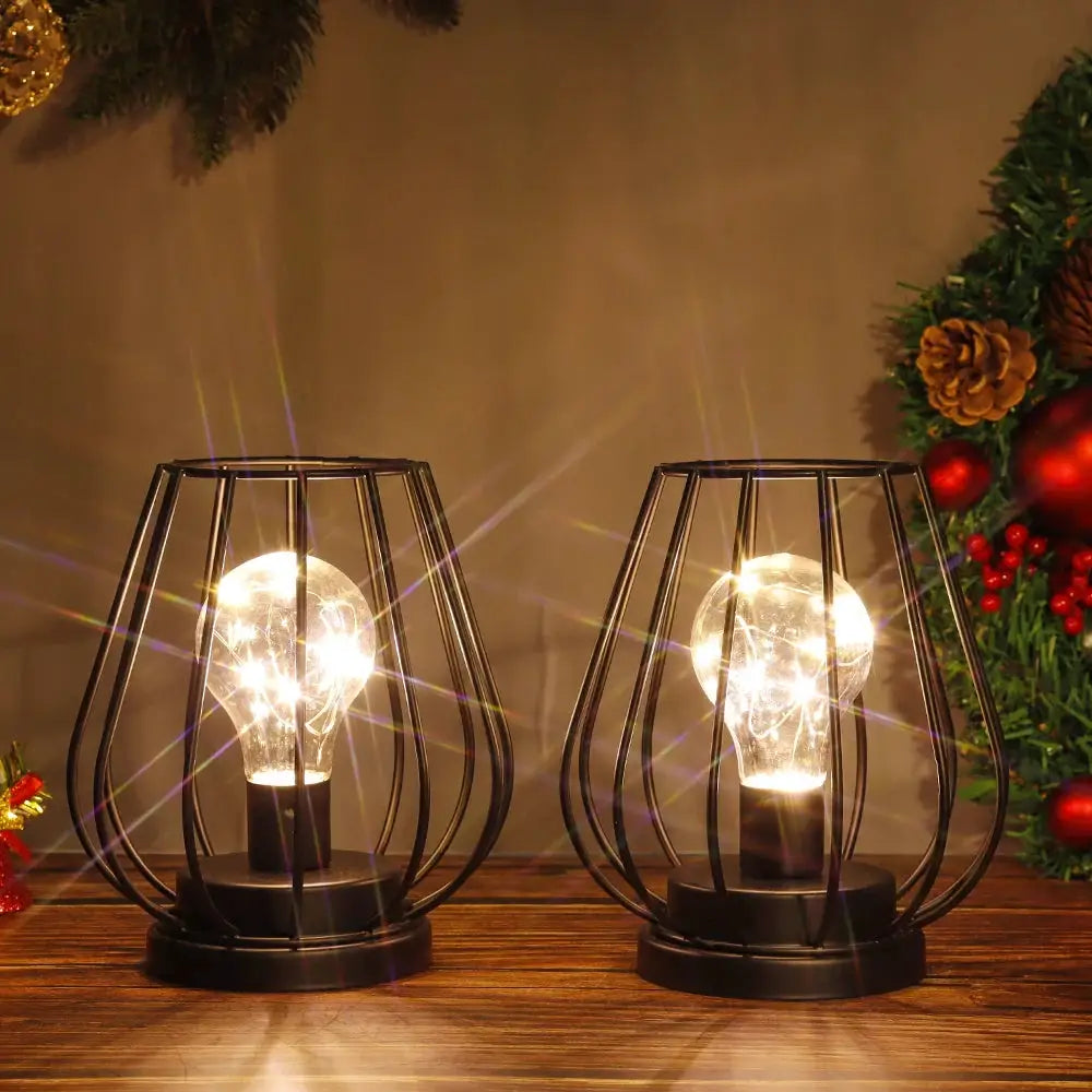 2-pack 7-inch tall black metal battery-operated lamps with cage-style frames and glowing bulbs.
